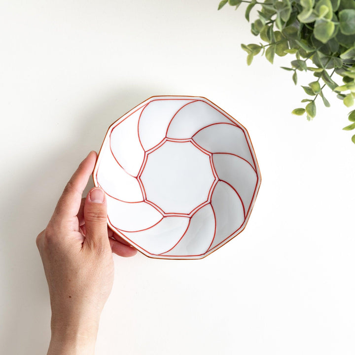 Octagonal dessert plate with a petal design and bowl shape, outlined in blue and red with a brown rim.