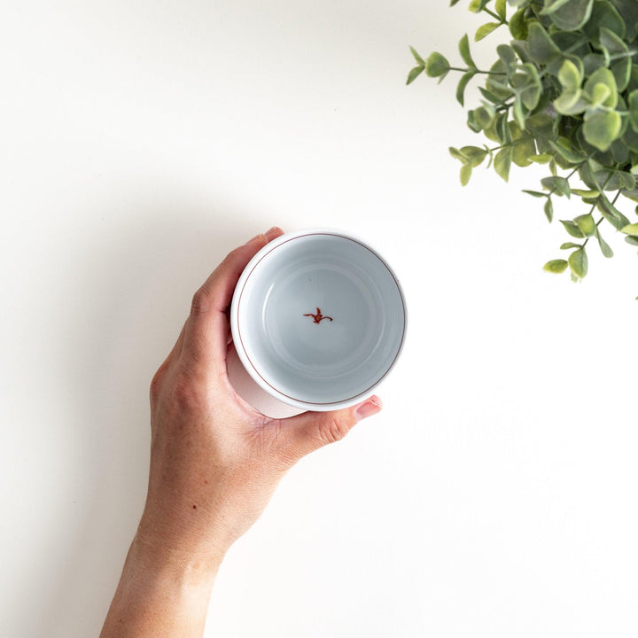 A small condiment bowl adorned with a blue or red geometric lattice pattern, providing a classic and intricate look.