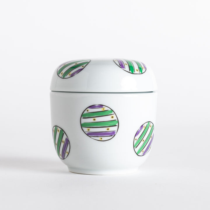 White bowl with a colorful pattern of alternating green and purple striped circles on the exterior.