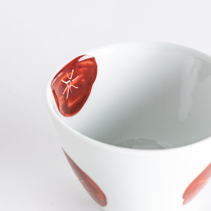 Close-up of the teacup highlighting its vibrant red design, perfect for a stylish tea presentation.