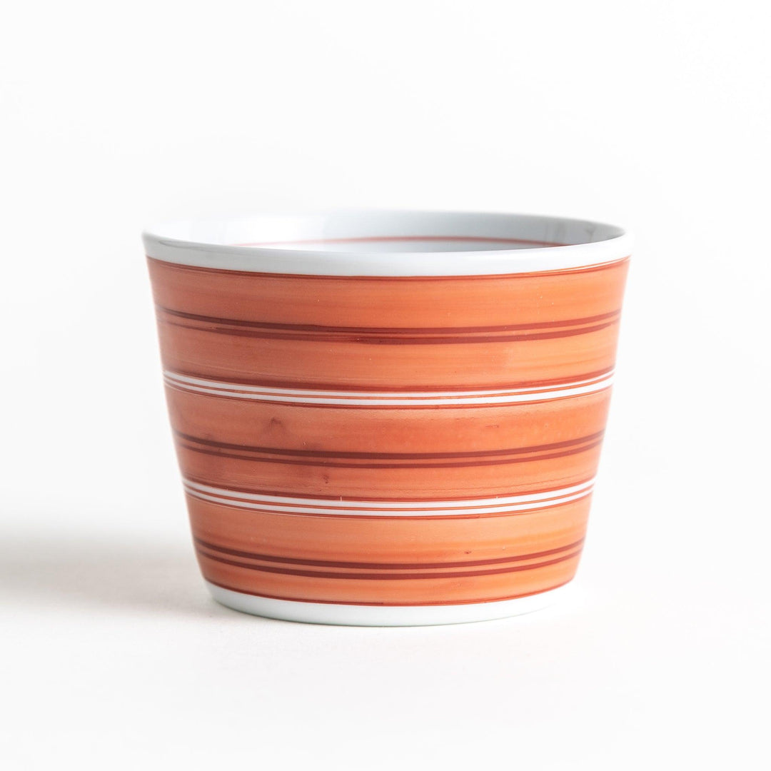 A small condiment bowl with horizontal blue or red stripes of varying shades, creating a minimalist yet elegant design.