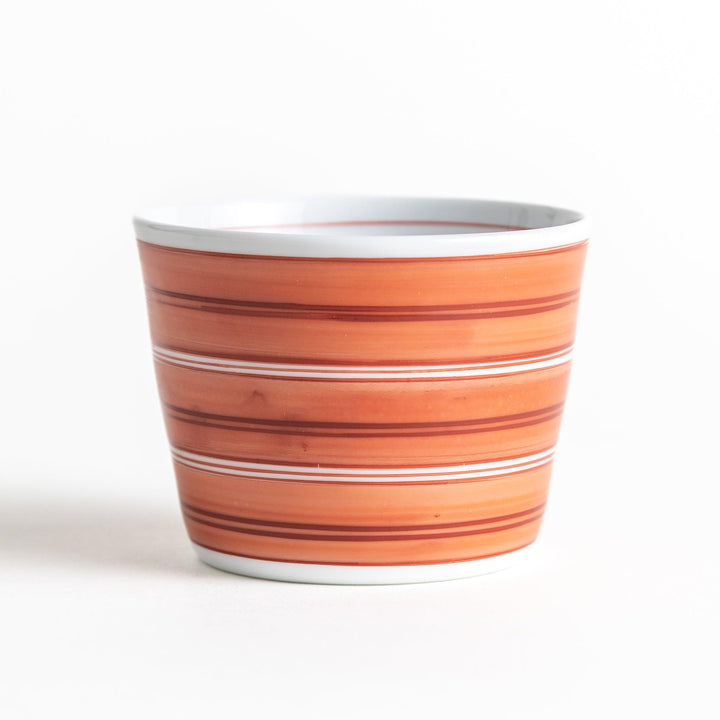 A small condiment bowl with horizontal blue or red stripes of varying shades, creating a minimalist yet elegant design.