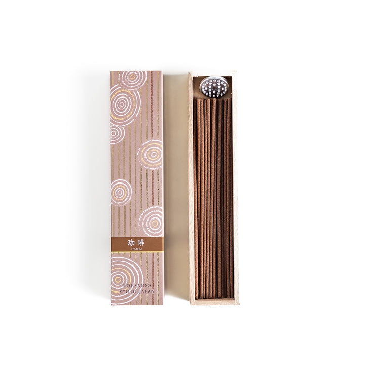 Incense in a light wooden box with rich brown sticks, elegantly packaged in a warm beige design featuring white circular patterns, evoking a soothing coffee aroma.