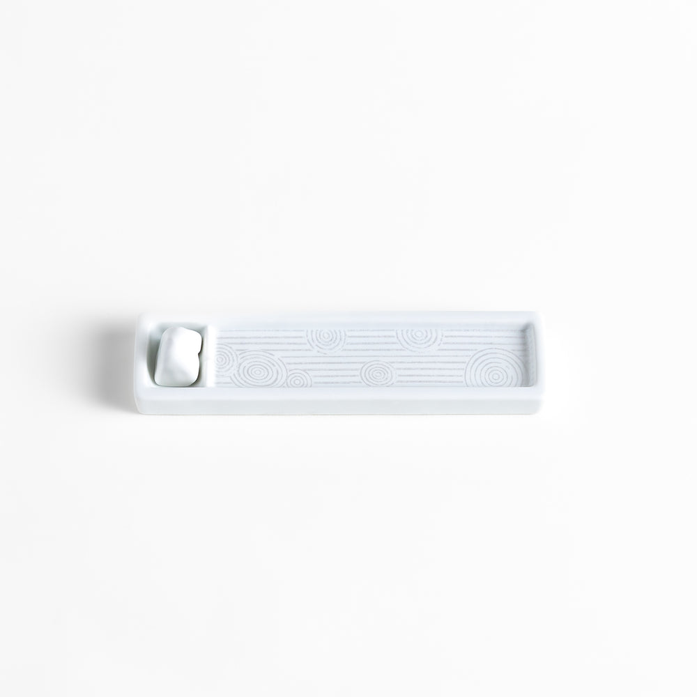 Zen-inspired white ceramic Incense Holder featuring a raked sand pattern.