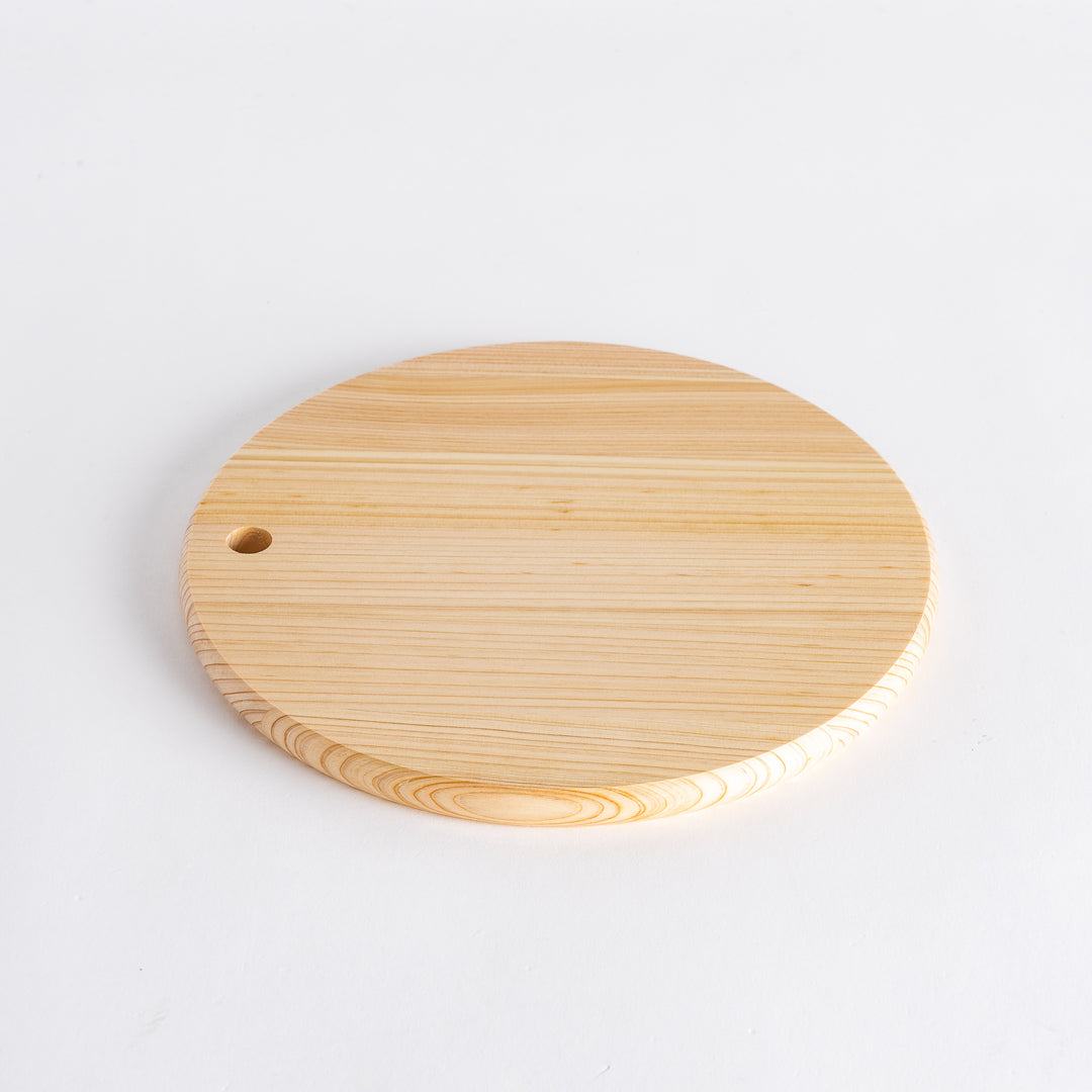 Round Hinoki cutting board viewed from above with a hole.