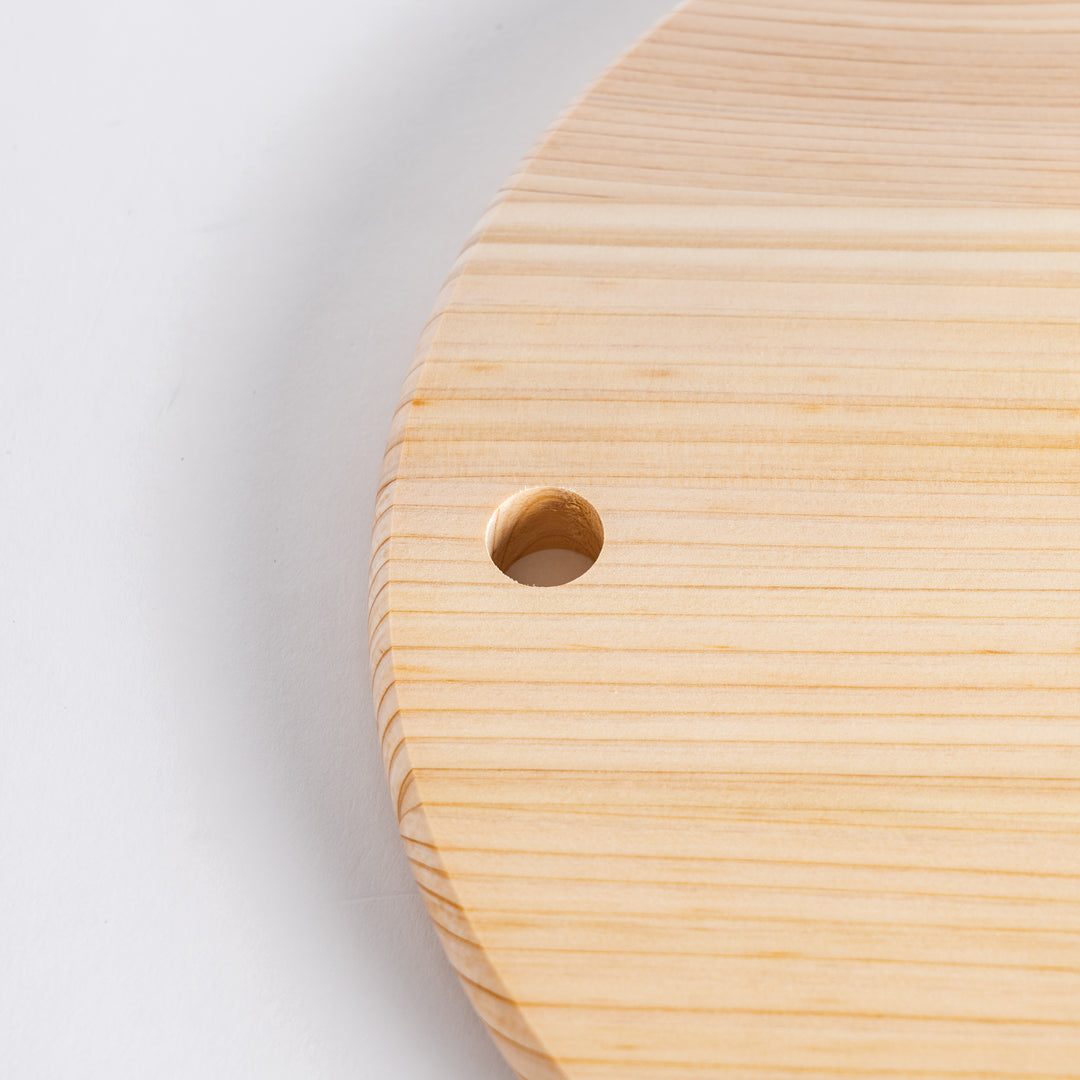 Close-up of the hole in the round Hinoki cutting board.