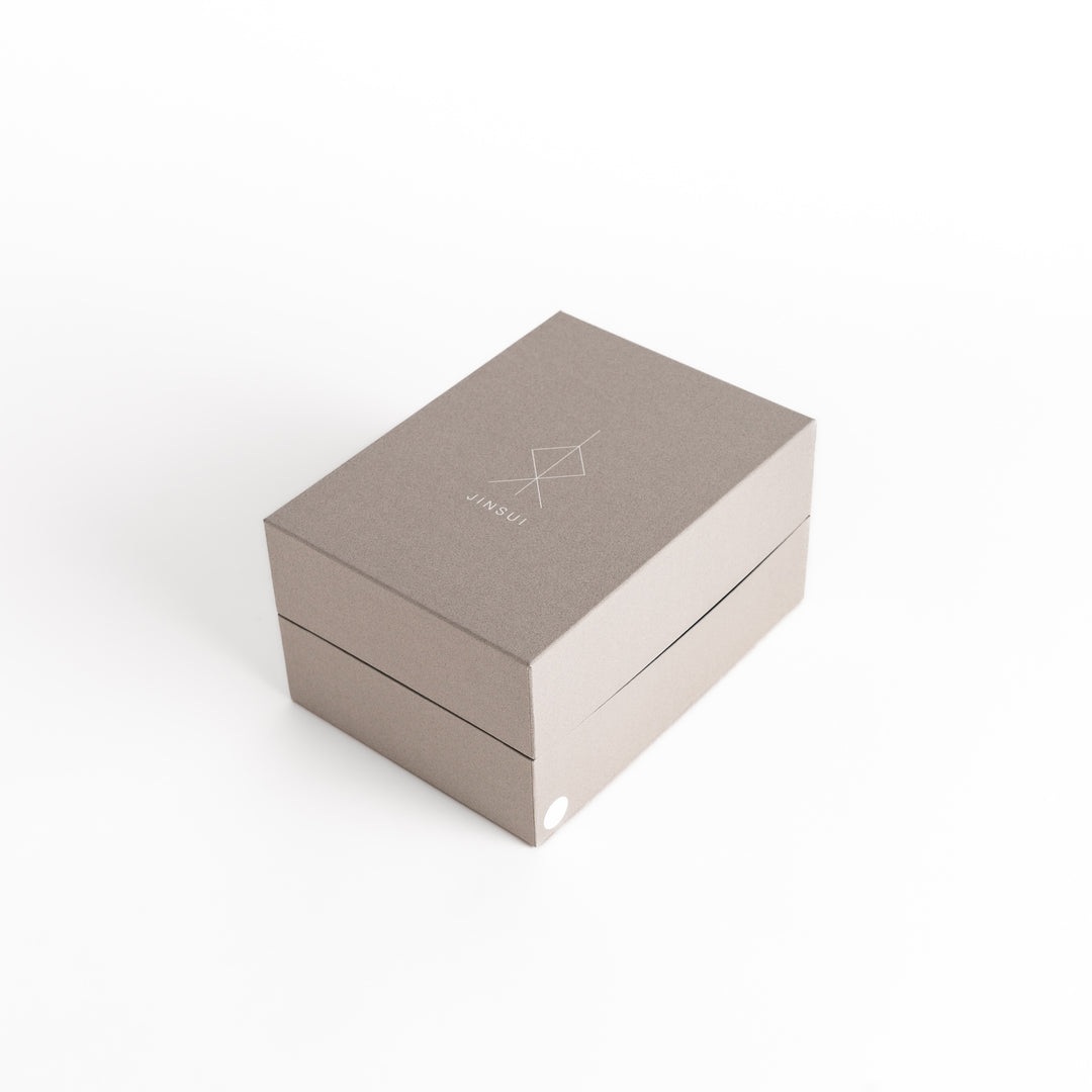 The teapot's packaging box featuring minimalist design, ensuring secure storage and gifting.