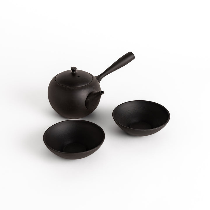 Matching black teacups paired with a teapot from the same series, creating a cohesive and sophisticated tea set.