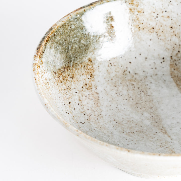 Close-up view showing the rim of the rustic earth-tone ramen bowl with a glossy finish and earthy textures.