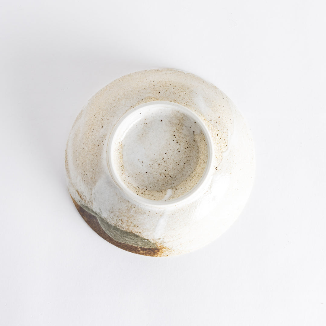 Bottom view of the rustic earth-tone ramen bowl showcasing its smooth base and textured surface.