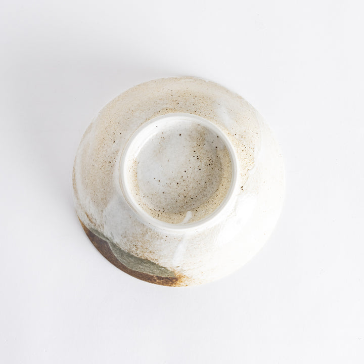 Bottom view of the rustic earth-tone ramen bowl showcasing its smooth base and textured surface.