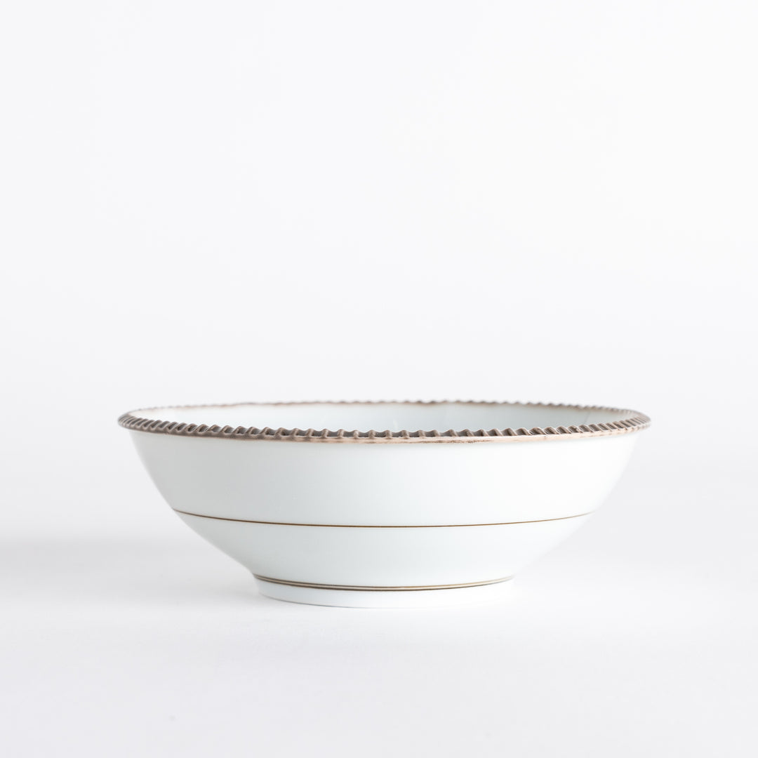 Side view of a cereal bowl featuring a smooth white body with rustic brown detailing along the rim, highlighting its unique design.