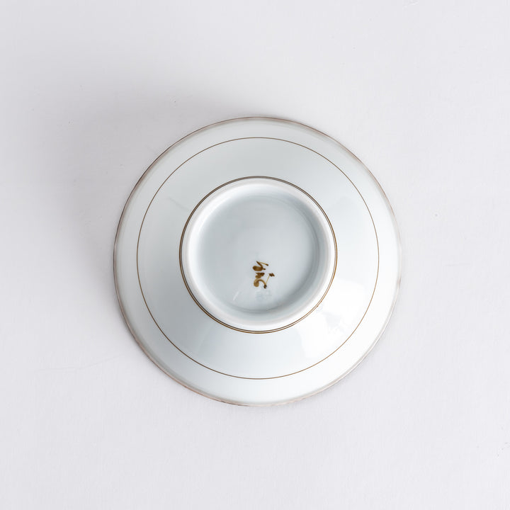 Underside view of the cereal bowl displaying manufacturer marks, with a smooth surface and subtle brown detailing.