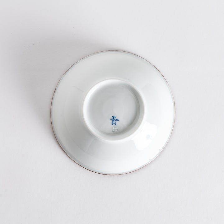 A round white cereal bowl with a rustic scallop-edged border. The border comes in blue, brown, and olive.