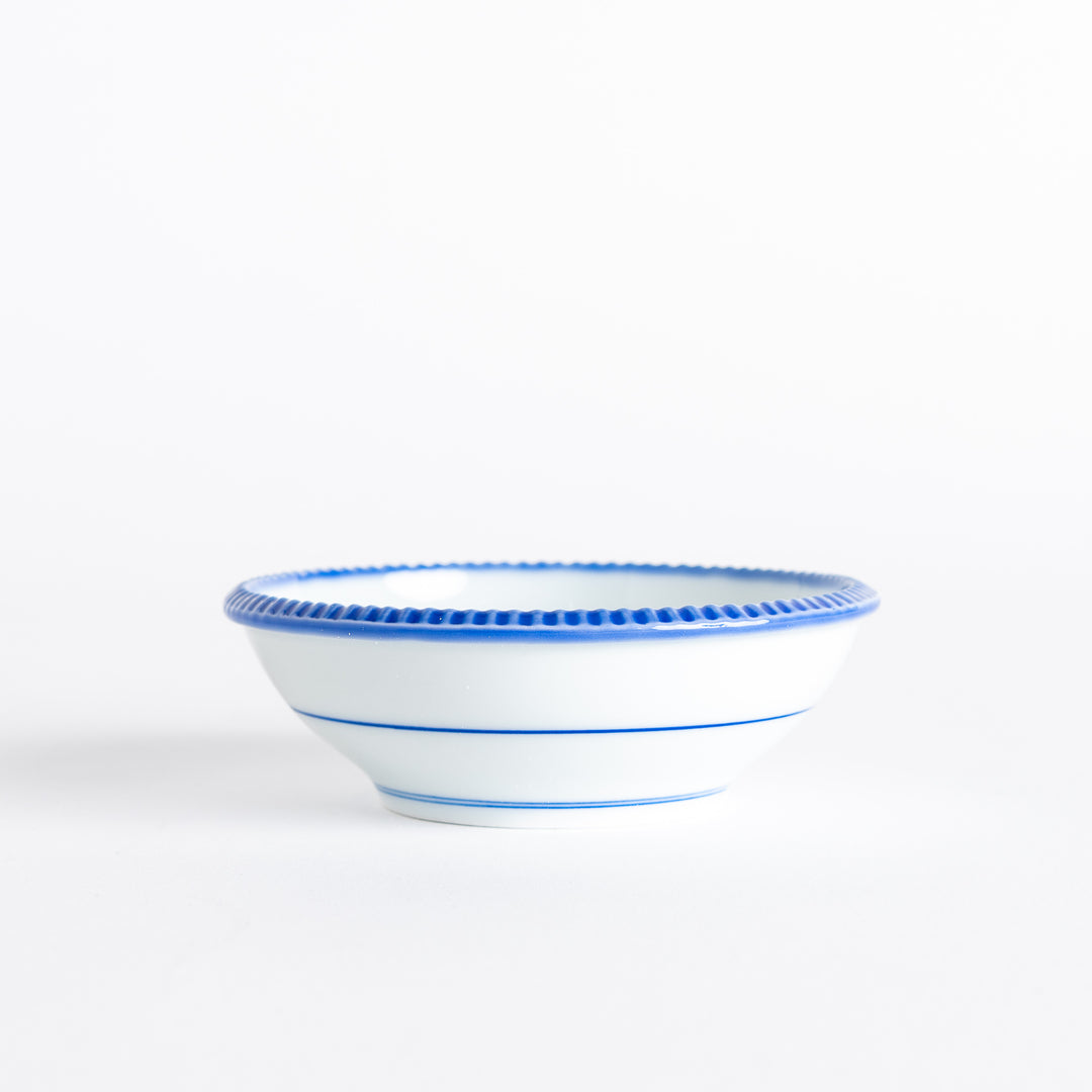 A round white dessert bowl with a rustic scallop-edged border. The border comes in blue, brown, and olive.