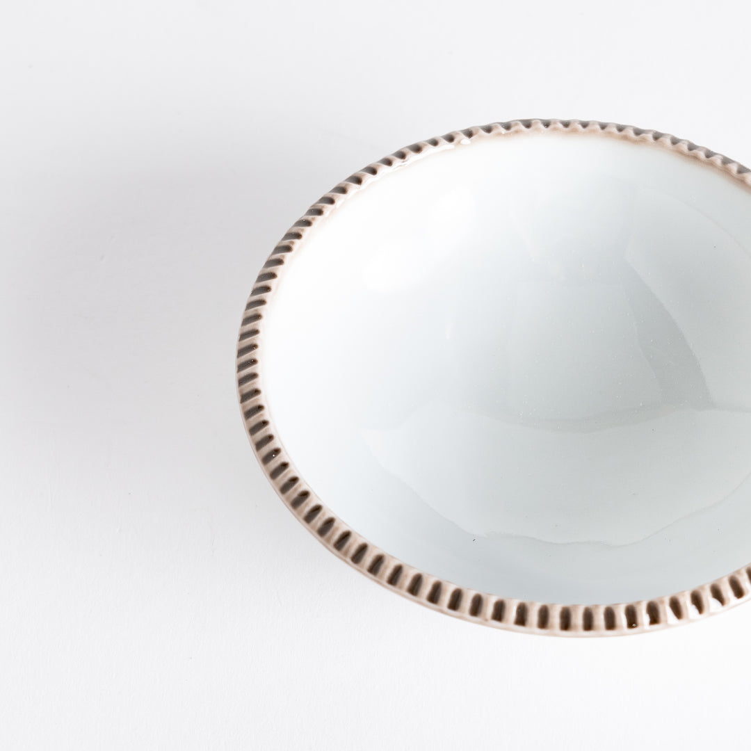 A round white dessert bowl with a rustic scallop-edged border. The border comes in blue, brown, and olive.