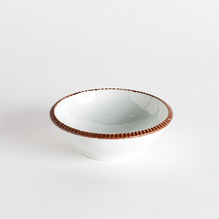 A round white dessert bowl with a rustic scallop-edged border. The border comes in blue, brown, and olive.