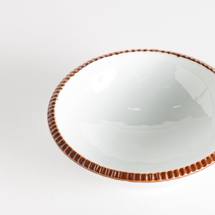 A round white dessert bowl with a rustic scallop-edged border. The border comes in blue, brown, and olive.