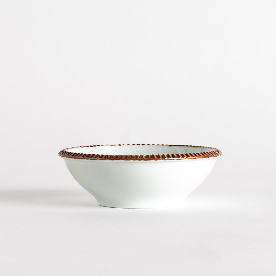 A round white dessert bowl with a rustic scallop-edged border. The border comes in blue, brown, and olive.