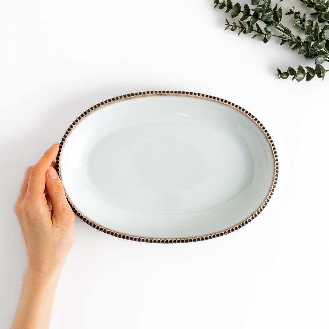 Classic white dinner plate with a unique beaded design, ideal for everyday dining or special occasions.