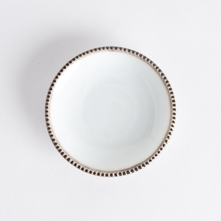 A round white sauce dish with a rustic scallop-edged border. The border comes in blue, brown, and olive.