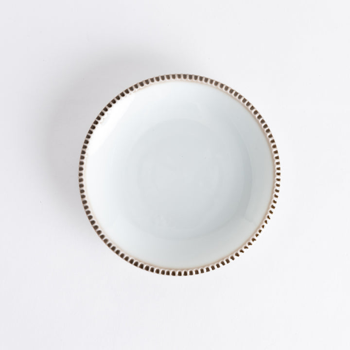 A round white dessert plate with a rustic scallop-edged border. The border comes in blue, brown, and olive.