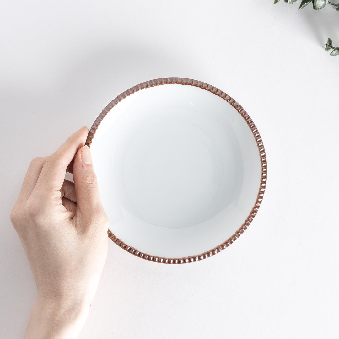 A round white dessert plate with a rustic scallop-edged border. The border comes in blue, brown, and olive.