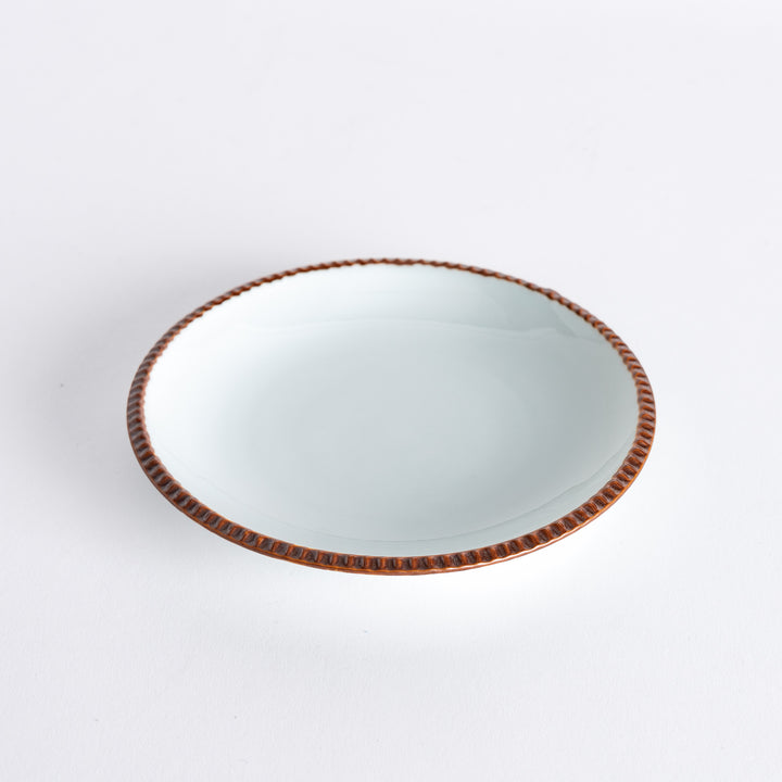 A round white dessert plate with a rustic scallop-edged border. The border comes in blue, brown, and olive.