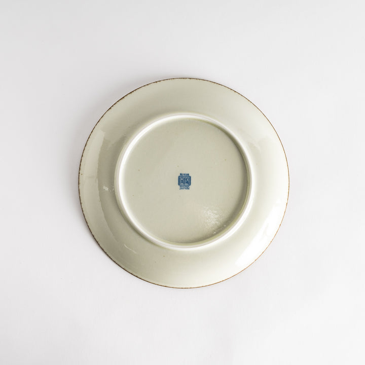 A round dinner plate featuring a striking pattern of blue lines radiating from the center.