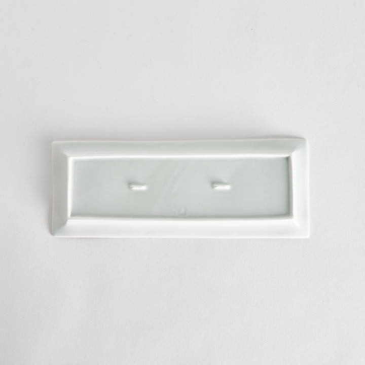 Back view of a rectangular plate, entirely white, showcasing its clean and simple base design.