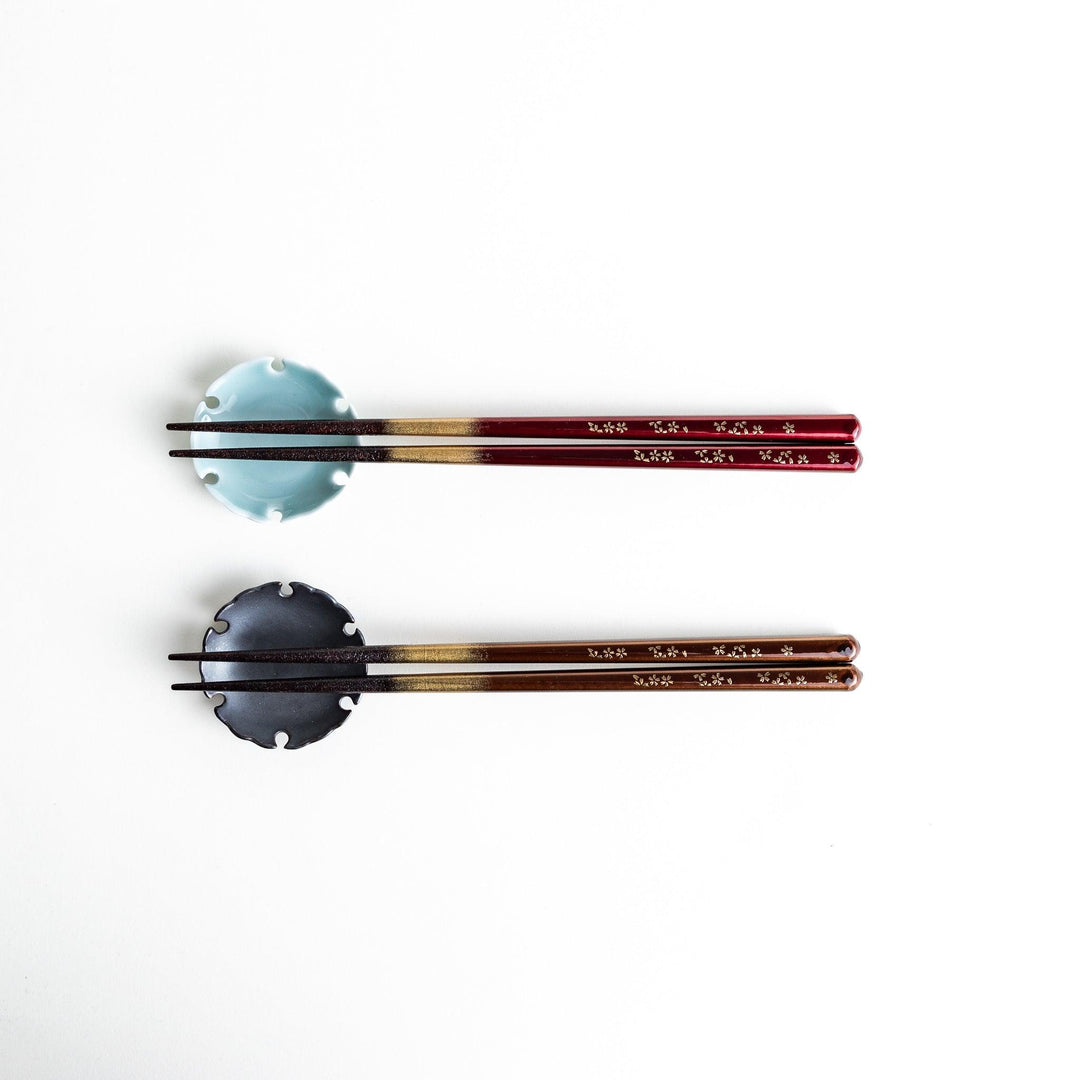 Elegant red and brown lacquered chopsticks adorned with delicate gold cherry blossom motifs, featuring a gradient of gold for added sophistication.