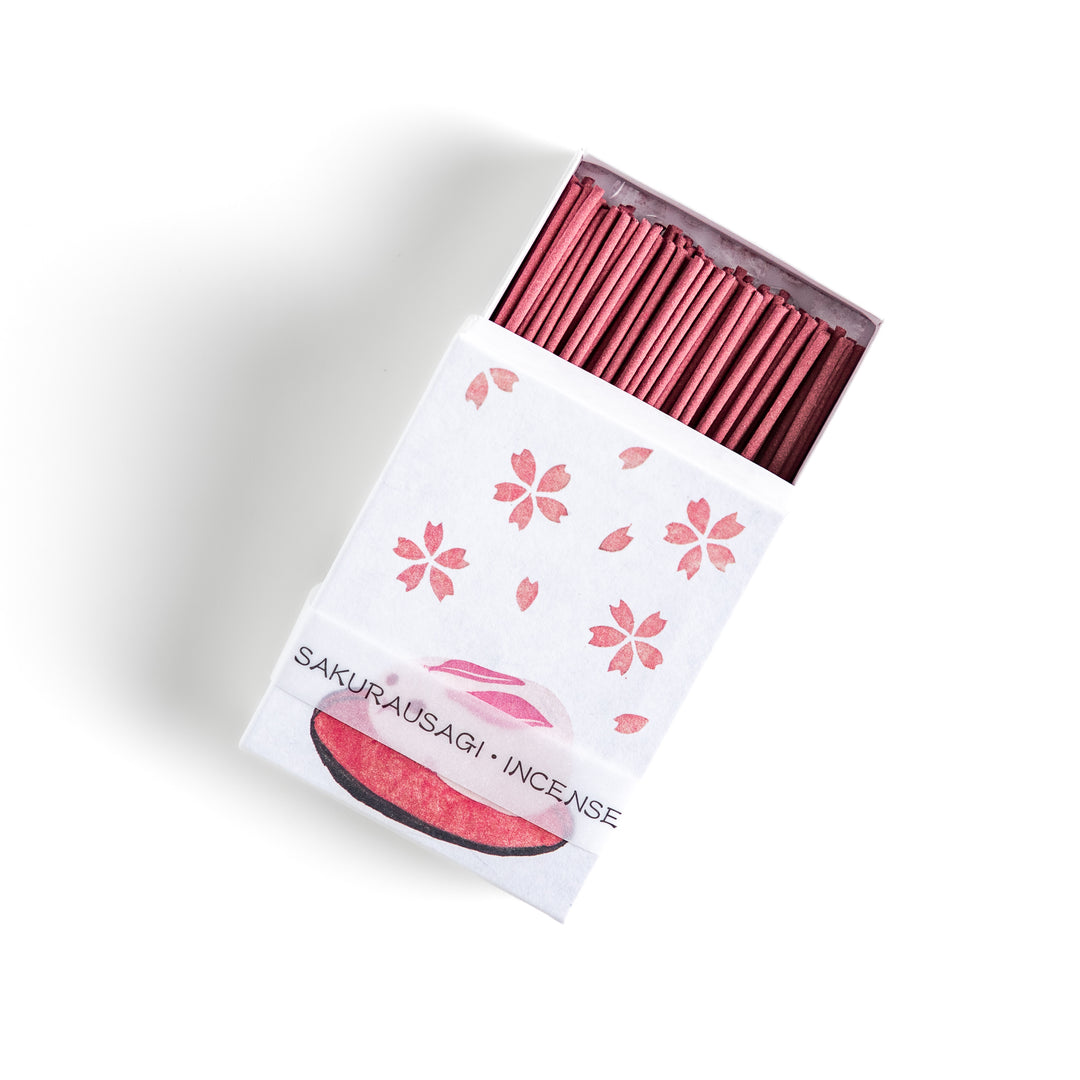 Incense featuring soft pink sticks in a box adorned with cherry blossoms and a rabbit motif, offering a delicate floral fragrance inspired by springtime sakura.