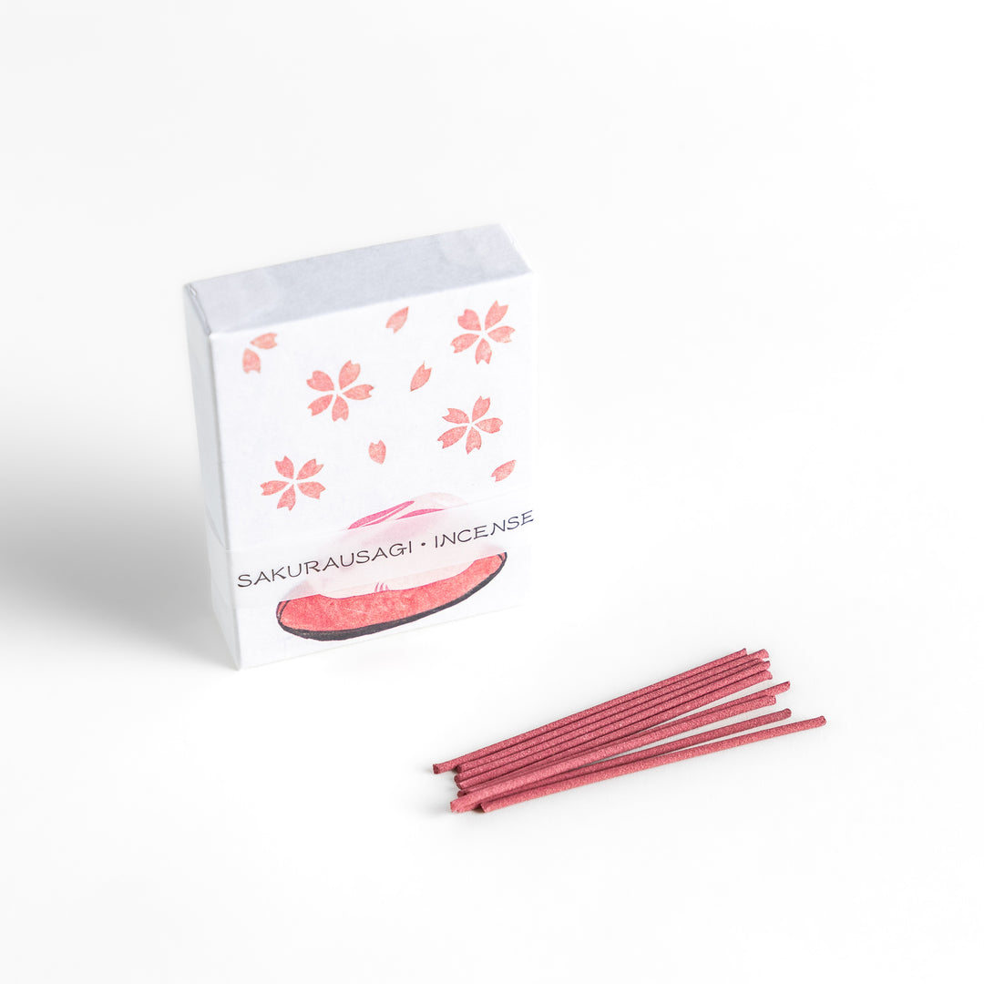 Incense featuring soft pink sticks in a box adorned with cherry blossoms and a rabbit motif, offering a delicate floral fragrance inspired by springtime sakura.