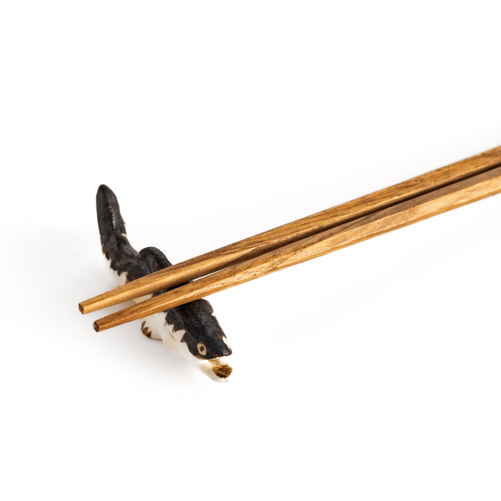 Close-up of chopsticks on the sweetfish-shaped rest, highlighting its intricate detailing and glaze transitions.