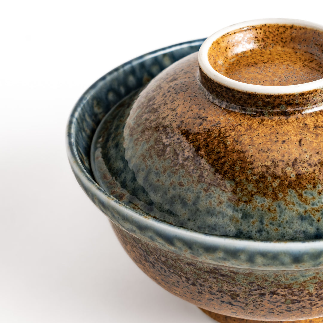 Ceramic donburi bowl with a reactive glaze in shades of brown and blue, complete with a lid, perfect for serving rice dishes, noodles, or soups in style.