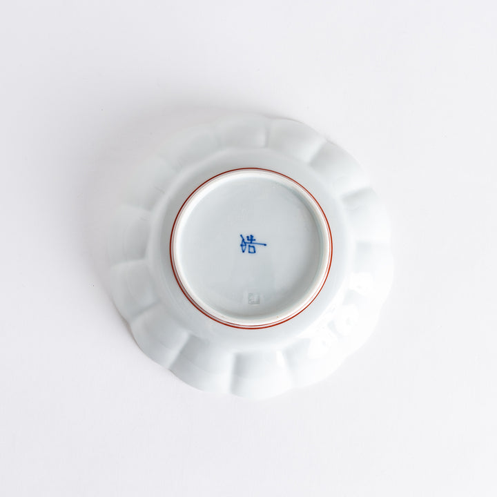 A small round dessert bowl with a delicate blue chrysanthemum pattern and scalloped edges.