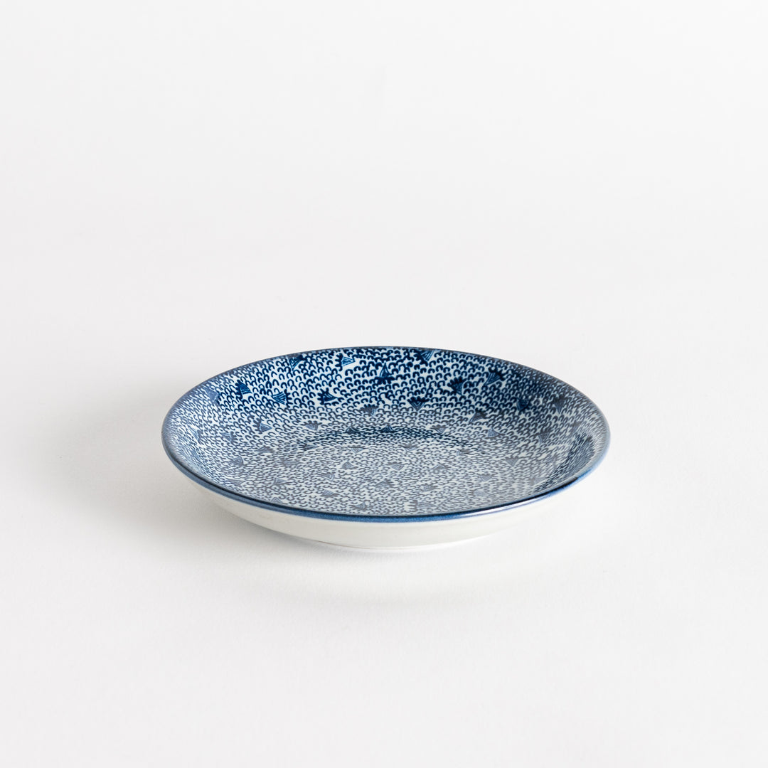 A shallow round plate with a speckled blue pattern covering the surface.