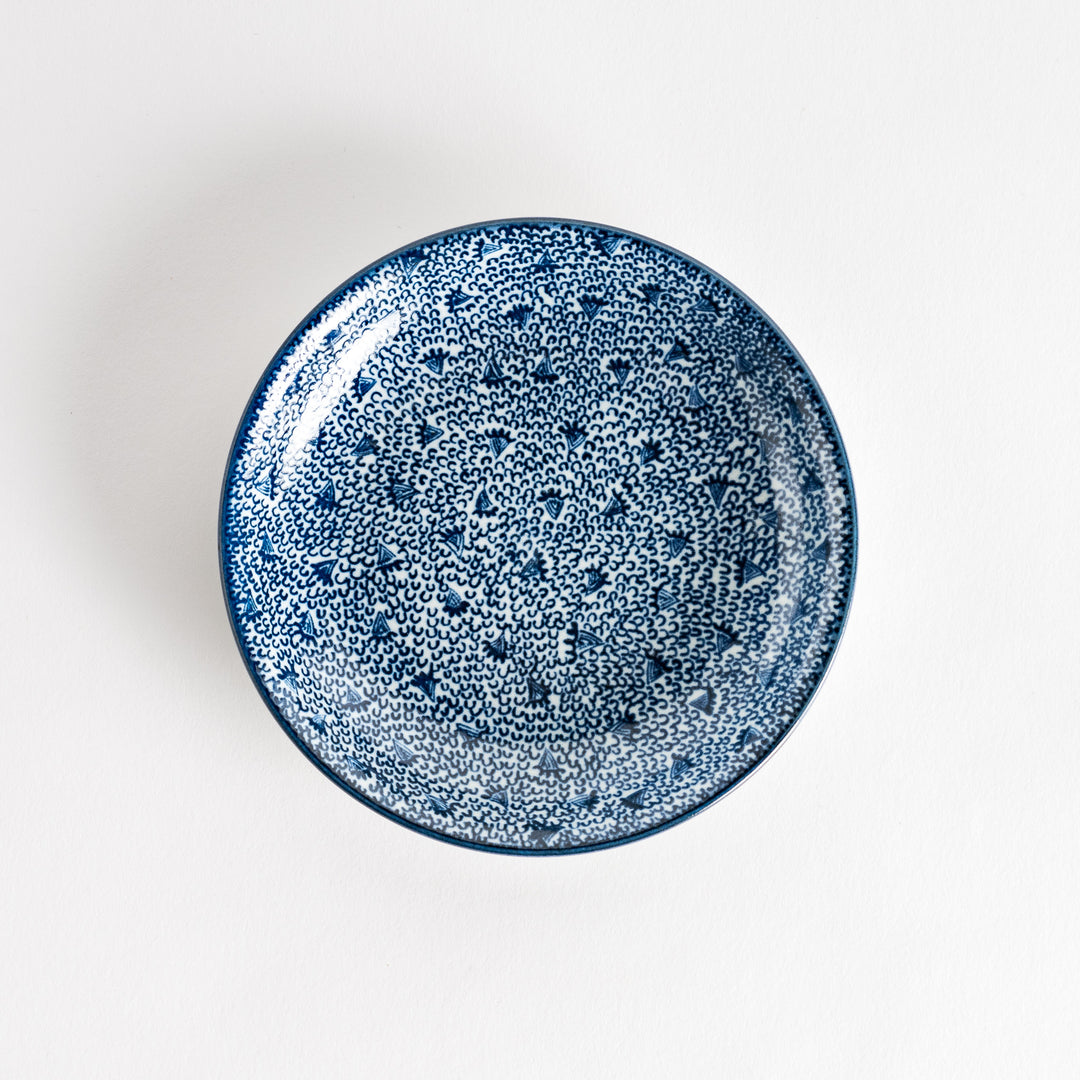 A shallow round plate with a speckled blue pattern covering the surface.