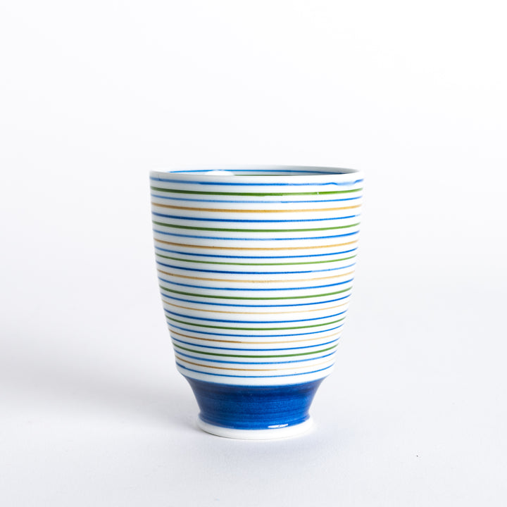 Side view of the Serene Striped Tea Cup, showcasing the vibrant blue, green, and yellow stripes and the blue base.