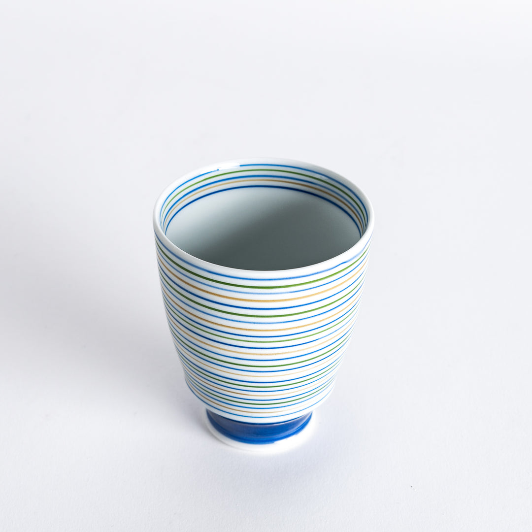 Serene Strip Tea Cup slightly angled, highlighting its curved shape and colorful horizontal stripes.