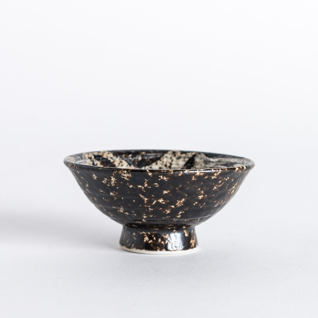 Side view of the silver rustic finish sake cup, highlighting its textured surface and black rim."