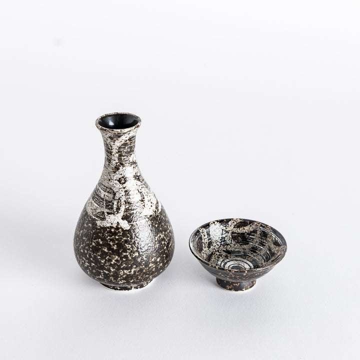 Side view of the rustic finish sake flask and sake cup, displaying the complementary designs of both.