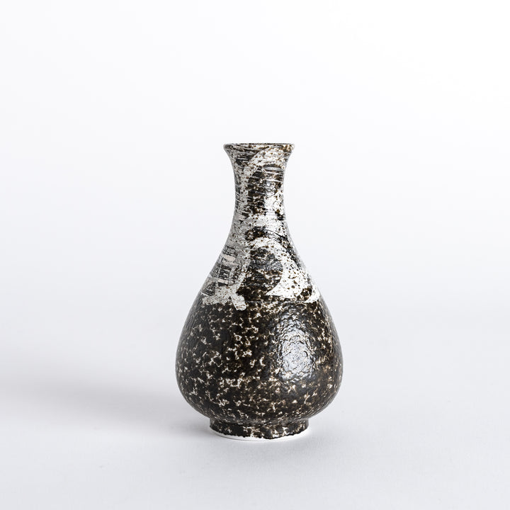 Side view of a sake flask featuring a textured dark surface with contrasting silver accents, showcasing its elegant and rustic design.