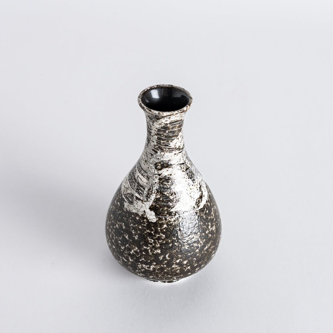 Slightly angled view of the sake flask, highlighting its unique rustic finish with silver accents and curved shape.