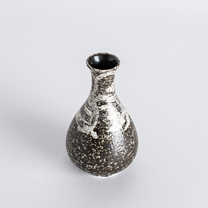 Slightly angled view of the sake flask, highlighting its unique rustic finish with silver accents and curved shape.