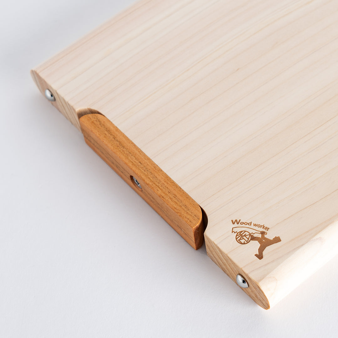 Small hinoki cutting board resting on a flat surface, showcasing its practical and stylish features.