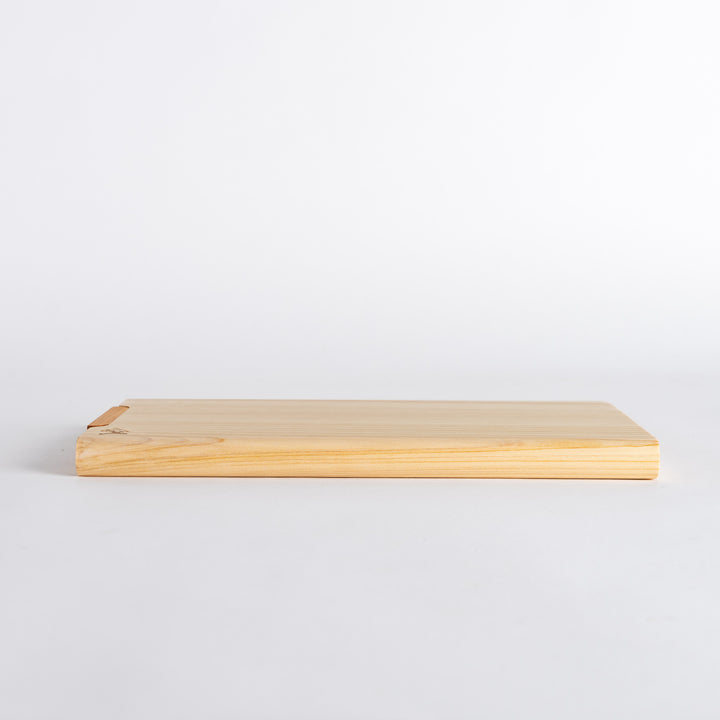 Side view of small hinoki cutting board, displaying the thickness and craftsmanship of the wood.