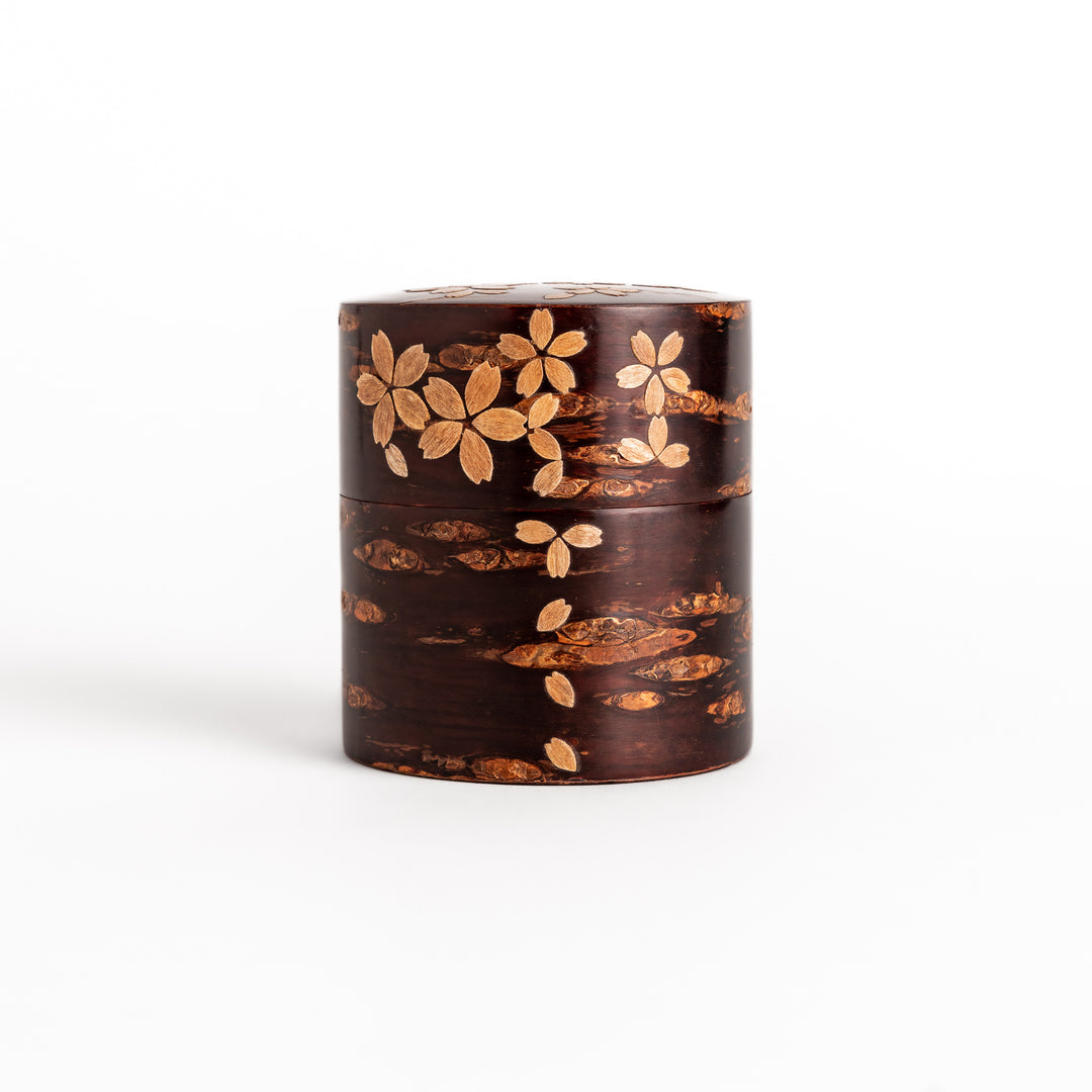 Elegant cherry bark tea canister with a beautiful natural grain and cherry blossom accents, perfect for storing and preserving your favorite tea leaves.