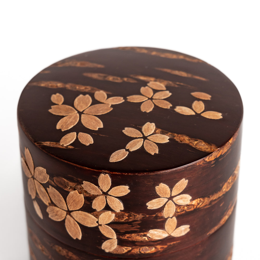 Elegant cherry bark tea canister with a beautiful natural grain and cherry blossom accents, perfect for storing and preserving your favorite tea leaves.