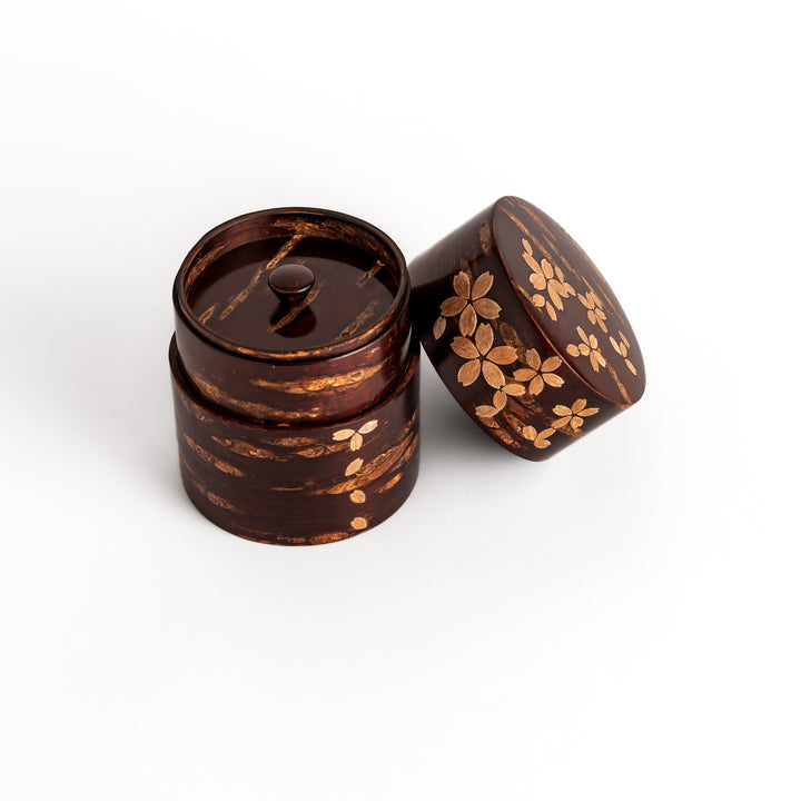 Elegant cherry bark tea canister with a beautiful natural grain and cherry blossom accents, perfect for storing and preserving your favorite tea leaves.